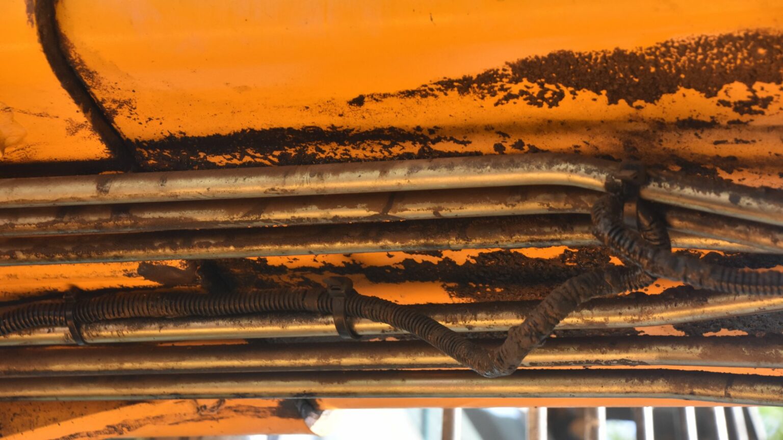 Hydraulic hose under a tractor on a farm. 