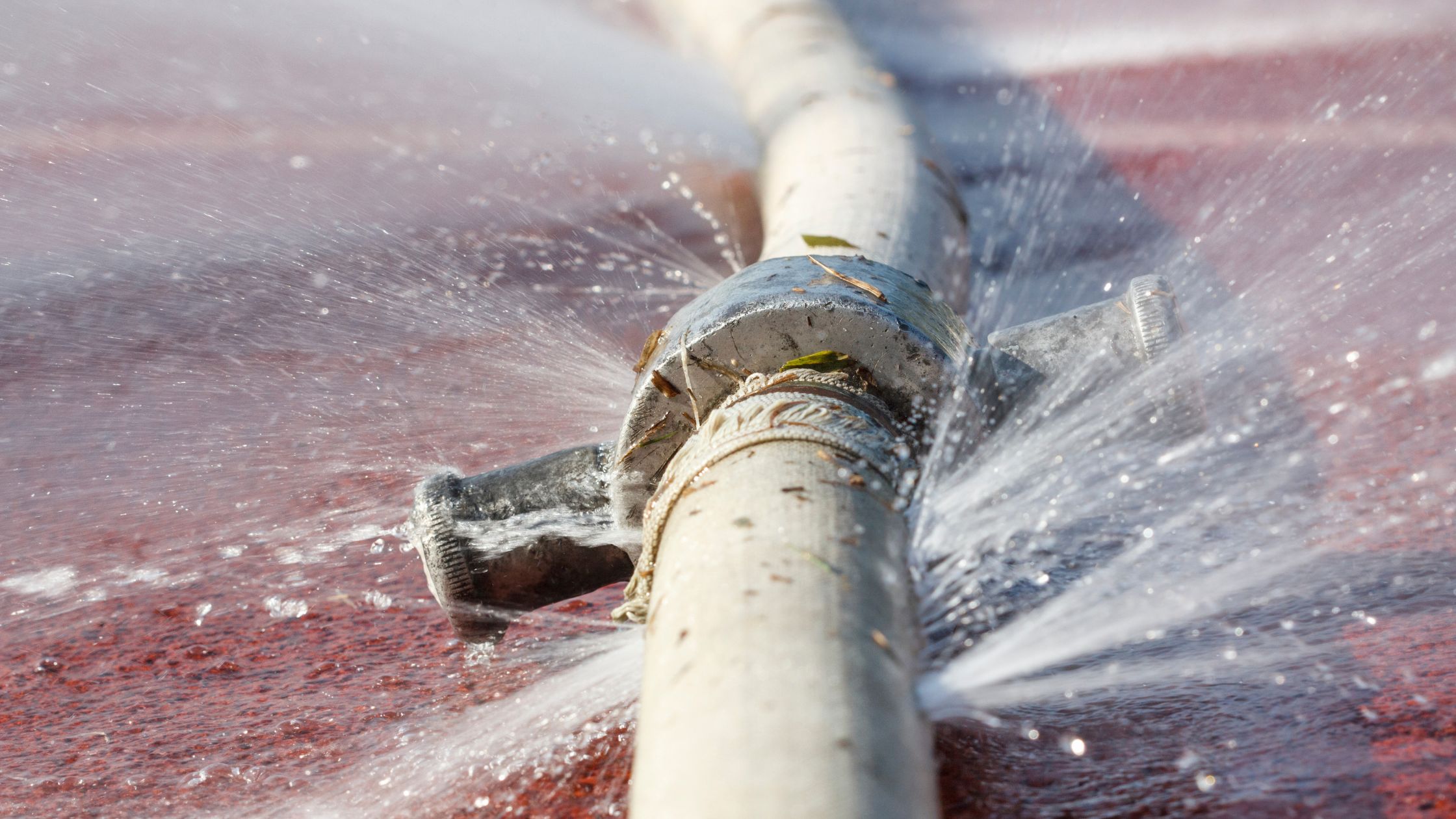 A hydraulic hose leaking from a mismatched hose connecter. 