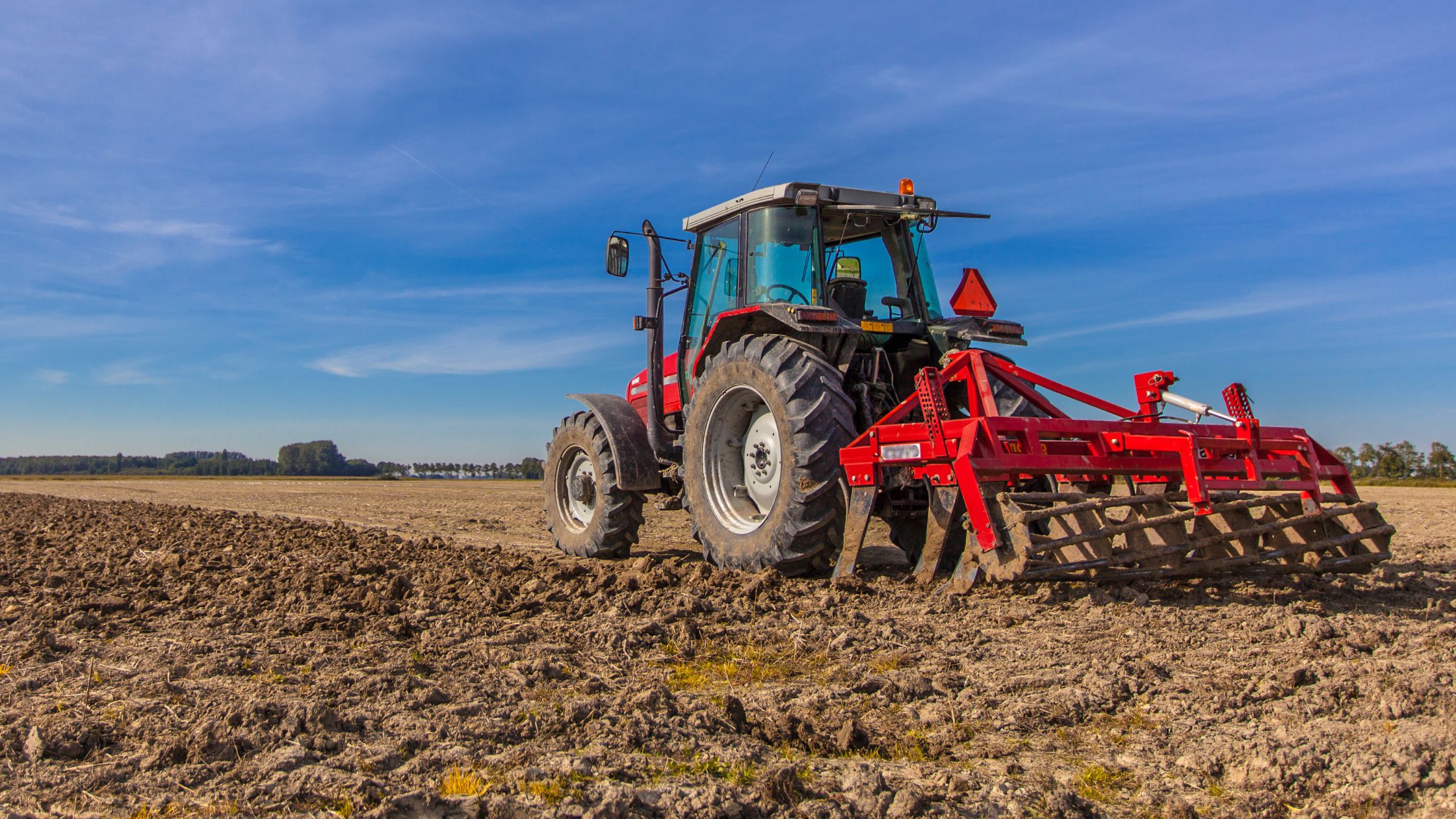 A tractor working the Massachusetts land